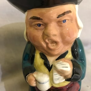 May include: A set of three ceramic mugs with a speckled, matte finish. Each mug is a different colour: light blue, cream, and grey. The mugs have a simple, modern design and a comfortable handle.