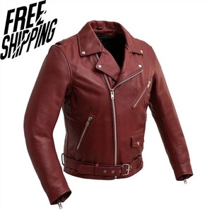May include: A deep red leather motorcycle jacket featuring a notched lapel with silver-toned metal snaps, an asymmetrical front zipper closure, multiple zippered pockets, a small flap pocket, and an adjustable waist belt with a metal buckle.