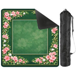 May include: A green golf putting mat with a floral border of pink flowers, white golf balls, and small white flags. The mat has a white square border and comes with a black carrying bag with a shoulder strap.