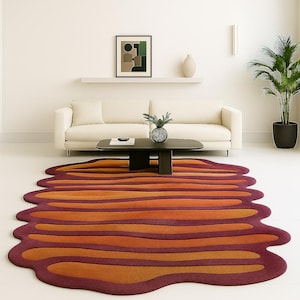 Large retro mid century modern rug placed under coffee table in neutral living room interior.