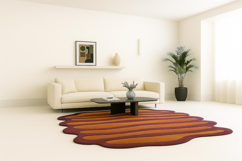 Wide living room shot featuring burnt orange irregular rug paired with modern cream couch and indoor plant.