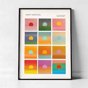 May include: A framed art print titled ANDY WARHOL SUNSET featuring a grid of twelve square panels. Each panel displays a stylized sunset with a solid colored circle representing the sun against a gradient background of varying hues including pink, blue, green, orange, and yellow.