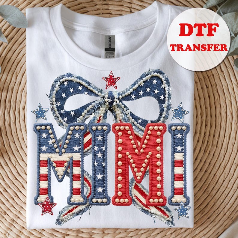 May include: White t-shirt featuring a patriotic design with the word "MIMI" in red and blue, adorned with stars and a bow. The design is a DTF transfer, perfect for creating custom apparel.