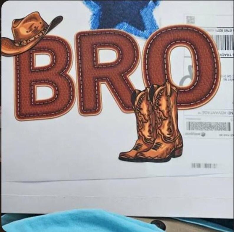 May include: A white background features the word "BRO" in brown, stitched letters, with a cowboy hat and boots. A blue star is in the background. The boots are brown and detailed.