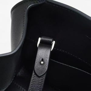 Sleek black minimalist leather shoulder bag with baguette handbag shape, structured leather bag featuring soft genuine leather and top handle design, convertible crossbody bag with detachable strap, aesthetic pinterest bag inspired by 90s baguette bag trend, everyday bag for daily essentials, zipper closure leather purse with compact storage, elegant classic handbag with quiet luxury style, minimalist work bag and trendy everyday bag, women leather bag perfect as gift for women