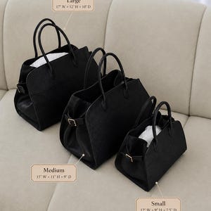 May include: Three black structured handbags in large, medium, and small sizes. The large bag measures 17 inches wide by 12 inches high by 10 inches deep. The medium bag is 15 inches wide by 11 inches high by 9 inches deep. The small bag is 12 inches wide by 9 inches high by 7.5 inches deep.