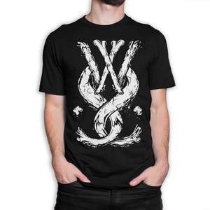 May include: Black t-shirt featuring a white graphic design. The design is a stylized emblem with intertwined bone-like shapes and the letters "W" and "X". The graphic has a distressed, textured appearance.
