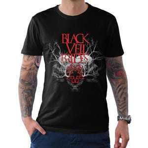 May include: Black t-shirt featuring the band name "Black Veil Brides" in red, with a skull and branch design. The graphic is centered on the front of the shirt. The shirt is short-sleeved.