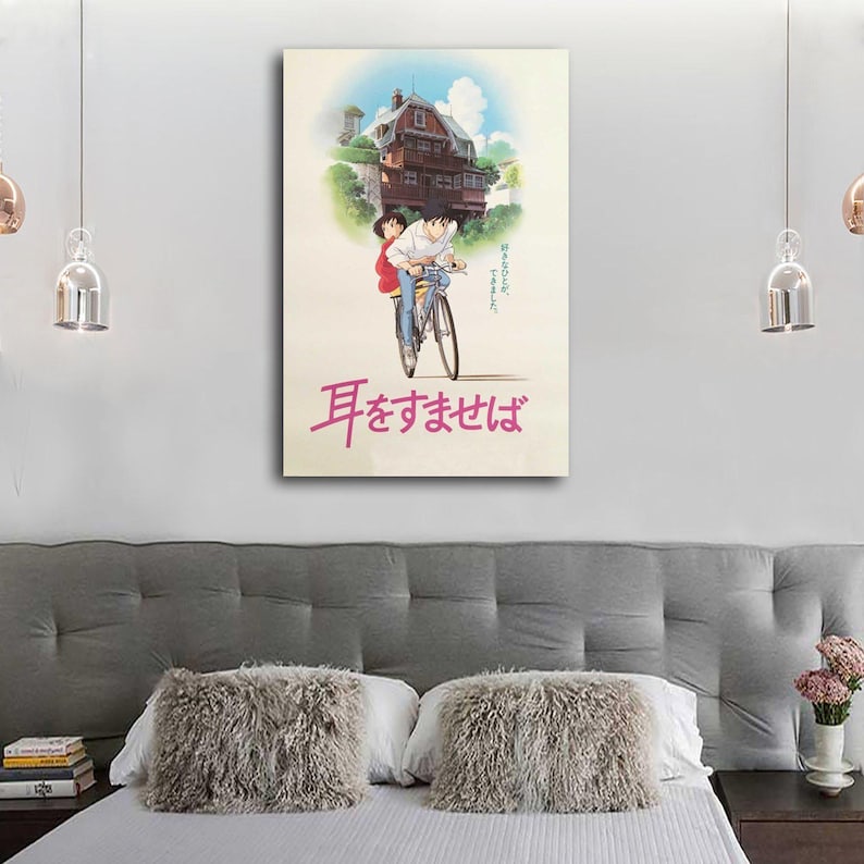May include: A framed poster featuring an anime-style illustration. The artwork depicts a couple riding a bicycle with a house in the background. Japanese text is visible at the bottom of the poster. The color palette includes shades of blue, red, and beige.
