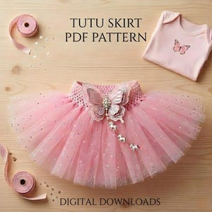 May include: A pink tutu skirt with a butterfly embellishment and a matching onesie with a butterfly design. The tutu has a crochet waistband and is adorned with silver glitter. Text on the image reads "TUTU SKIRT PDF PATTERN" and "DIGITAL DOWNLOADS."