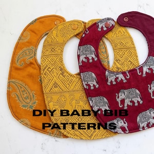 May include: Three handmade baby bibs with distinctive patterns. One is mustard yellow with a paisley design, another is gold with a geometric pattern, and the third is burgundy with elephant motifs. The text "DIY BABY BIB PATTERNS" is displayed.