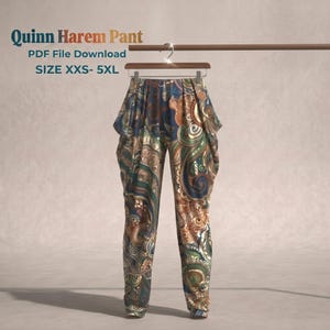 May include: Quinn Harem Pant PDF File Download SIZE XXS- 5XL. Harem pants featuring a complex, swirling paisley-inspired pattern in shades of deep blue, copper, bronze, and muted green. The pants hang from a wooden hanger on a horizontal rod.