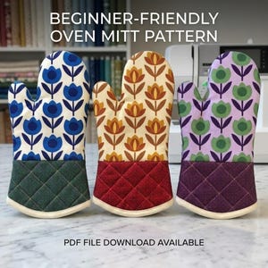 May include: Three oven mitts with floral patterns and quilted cuffs. The left mitt is blue and white with a dark green cuff, the center is orange and cream with a red cuff, and the right is green and purple with a dark purple cuff. Text reads: BEGINNER-FRIENDLY OVEN MITT PATTERN. PDF FILE DOWNLOAD AVAILABLE.