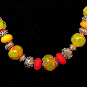 Perfect for fall. Orange and olive custom glass beads with sterling silver. 7&quot; bracelet B3