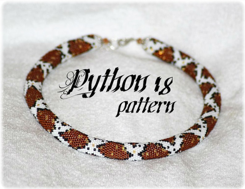 May include: A brown and white beaded necklace with a python skin pattern. The necklace is made with small beads and has a silver clasp.