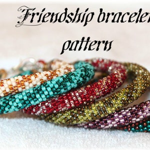 May include: Six colourful friendship bracelets made with small beads in a variety of colours, including white, brown, turquoise, red, green, and purple. The bracelets are stacked on top of each other, with the white and brown bracelet at the bottom and the purple and green bracelet at the top.