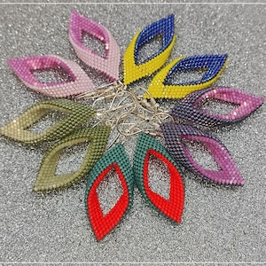 May include: A set of eight beaded earrings in various colors, including green, purple, pink, yellow, blue, and red. The earrings are shaped like a teardrop with a small hole at the top for a hook.