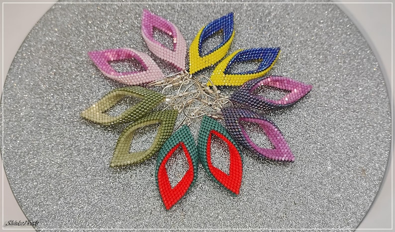 May include: A set of eight beaded earrings in various colors, including green, purple, pink, yellow, blue, and red. The earrings are shaped like a teardrop with a small hole at the top for a hook.