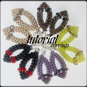 May include: A set of eight beaded earrings in various colors, including beige, brown, black, purple, and green. The earrings are all oval-shaped and feature a crystal bead at the bottom. The earrings are arranged in a circle on a white surface. The text "tutorial earrings" is visible in the center of the image.