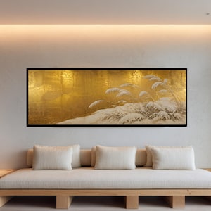 May include: A rectangular wall art piece featuring a metallic gold background with a detailed illustration of white, snow-covered tall grasses. The artwork is enclosed in a thin black frame and displays a high-contrast scene of winter flora.