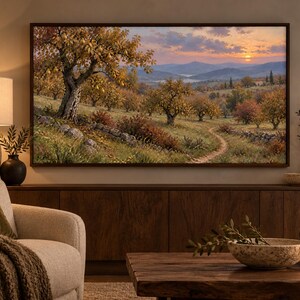 May include: A rectangular wall-mounted television displaying a landscape painting of an orchard with golden-hued trees, a stone wall, and a winding dirt path under a sunset sky with distant mountains, framed in a dark brown wooden border.