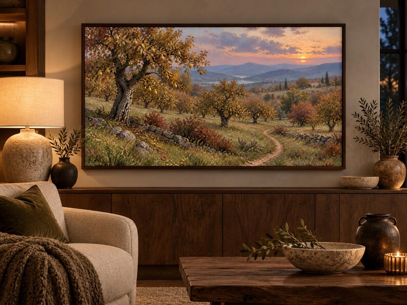 May include: A rectangular wall-mounted television displaying a landscape painting of an orchard with golden-hued trees, a stone wall, and a winding dirt path under a sunset sky with distant mountains, framed in a dark brown wooden border.