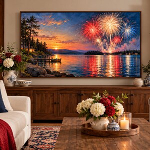 May include: A large rectangular wall art print featuring a vibrant sunset over a lake with colorful fireworks exploding in the sky. The scene includes a dark shoreline with trees, a small boat on the water, and reflections of the fireworks on the lake.