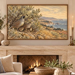 May include: A rectangular framed wall art print featuring a detailed landscape painting of a family of California quail perched on a rocky hillside overlooking a coastal ocean scene with cliffs, rolling hills, and a soft, golden-toned sky.