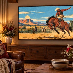 May include: A large rectangular television screen displaying a vibrant painting of a cowboy riding a bucking brown horse in a desert landscape with mesas, a bright sun, and a wooden fence, mounted on a wall above a wooden media console cabinet.