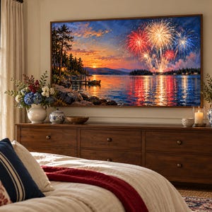 May include: A large rectangular wall art print featuring a vibrant sunset over a lake with colorful fireworks exploding in the sky. The scene includes a dark shoreline with trees, a small boat, and reflections of the fireworks on the water.