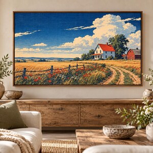 Puede incluir: Una impresi&oacute;n de arte mural rectangular enmarcada que representa un paisaje rural con una casa blanca de techo rojo, un granero rojo, un campo de trigo dorado, una valla de madera y amapolas rojas bajo un cielo azul brillante con grandes nubes blancas.