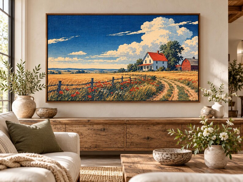 Puede incluir: Una impresi&oacute;n de arte mural rectangular enmarcada que representa un paisaje rural con una casa blanca de techo rojo, un granero rojo, un campo de trigo dorado, una valla de madera y amapolas rojas bajo un cielo azul brillante con grandes nubes blancas.