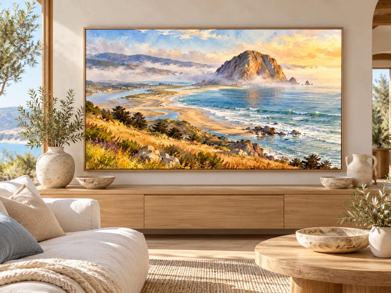 May include: A large rectangular landscape painting in a thin wooden frame depicting a coastal scene with a prominent rock formation, rolling hills, and a sandy beach. The artwork features a vibrant sky, blue ocean waves, and golden grassy terrain.