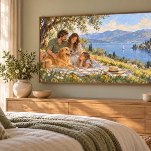 May include: A rectangular wall art print depicting a family of three and a golden retriever sitting on a picnic blanket under a tree. The scene features a scenic lake, distant mountains, and a sailboat under a bright blue sky with scattered clouds.