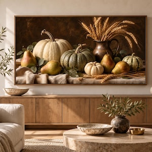 May include: A rectangular wall art print featuring a still life composition of various pumpkins, gourds, and pears arranged on a draped cloth. A dark copper pitcher filled with golden wheat stalks stands behind the fruit against a dark background.