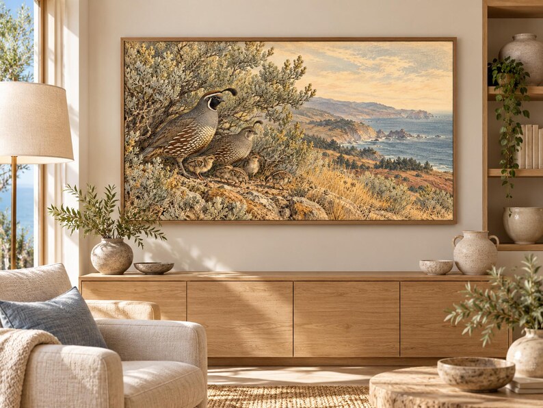 May include: A rectangular framed wall art print featuring a detailed illustration of a family of California quail perched on a rocky hillside overlooking a coastal landscape with a blue ocean, golden cliffs, and a soft, hazy sky.