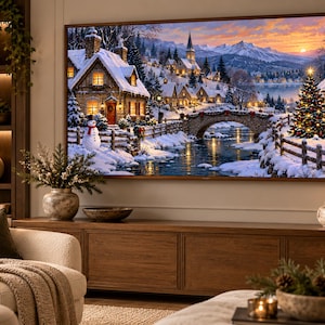 May include: A large rectangular television screen displaying a vibrant winter landscape painting featuring a snow-covered village, a stone bridge over a river, a decorated Christmas tree, and a snowman under a sunset sky with distant mountains.