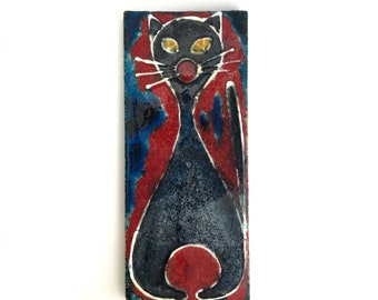 A Playful black cat, mid-century wall plaque, with beautiful crazing effect, presumably a Russel-Tiglia, Tegelen, Dutch/European art pottery