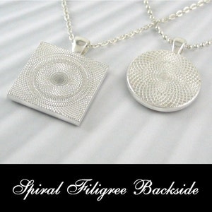 May include: Two silver necklaces with pendants. One pendant is a square with a spiral design, the other is a circle with a spiral design. The text "Spiral Filigree Backside" is at the bottom of the image.