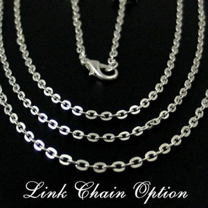 May include: Three silver chain necklaces with a lobster clasp closure. The chains are layered on top of each other, with the thickest chain on the bottom and the thinnest chain on top. The chains are all the same length.  Link Chain Option.