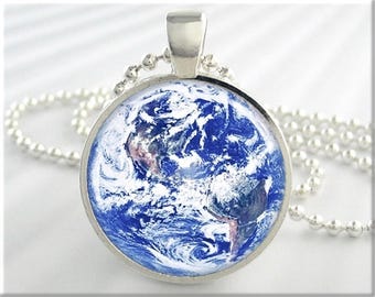 May include: A silver chain necklace with a round pendant featuring a blue and white image of the Earth.