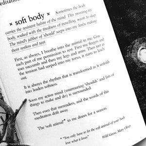 May include: A black and white image of an open book with text about meditation and the body. The text reads "x soft body x" and "Sometimes the body carries the resistant habits of the mind. This morning my body, soaked with the tiredness of traveling, wants to sleep. The mind's jabber of 'should' seeps into my limbs making them restless and taut."