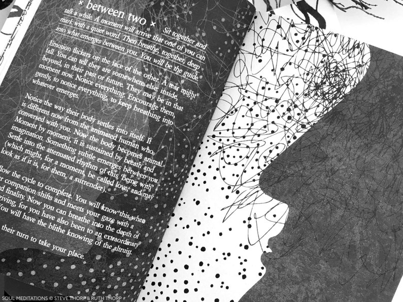 May include: Black and white image of a person's face with a background of scribbles and dots. The text "between two" is visible in the upper left corner of the image.