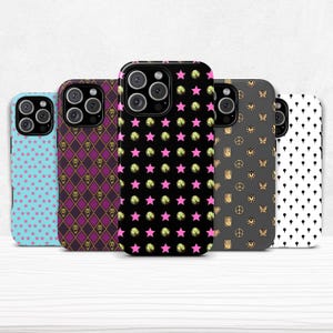 May include: A collection of five phone cases with various patterns. Designs include stars, skulls, and geometric shapes in colors like blue, purple, black, and white. The cases are designed to fit a smartphone.