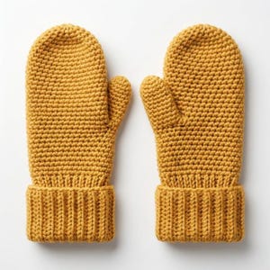May include: A pair of mustard yellow knitted mittens. The mittens have a ribbed cuff and a textured, crocheted appearance. The thumb is separate from the other fingers. The mittens are displayed on a white background.
