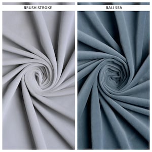 May include: Two fabric swatches, one light gray and one blue-gray, are displayed. The light gray swatch is labeled "BRUSH STROKE" and the blue-gray swatch is labeled "BALI SEA". Both fabrics are swirled to show texture.