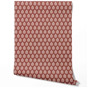 May include: A roll of wallpaper featuring a repeating pattern of white floral motifs on a terracotta background. The design is symmetrical and covers the entire surface, creating a textured appearance.