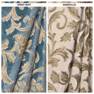 May include: Two sections of fabric, one in teal with gold floral patterns, labeled "SPRAY MIST," and the other in cream with gold floral patterns, labeled "AMARYLLIS." The fabrics are folded, showcasing the texture and design.