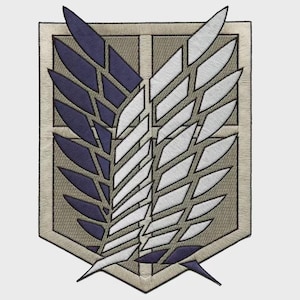 May include: A shield-shaped embroidered patch featuring a central vertical line dividing two stylized wings. The left wing is dark blue, and the right wing is white. The background of the shield is a light tan color with a dark border outline.