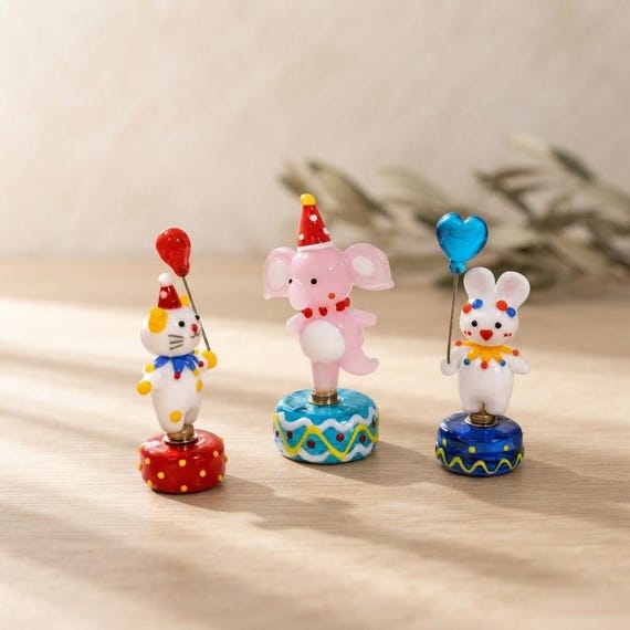 Tiny hand-blown glass circus animals — each one a miniature act of lampworking skill that looks like it escaped a Victorian curiosity cabinet.